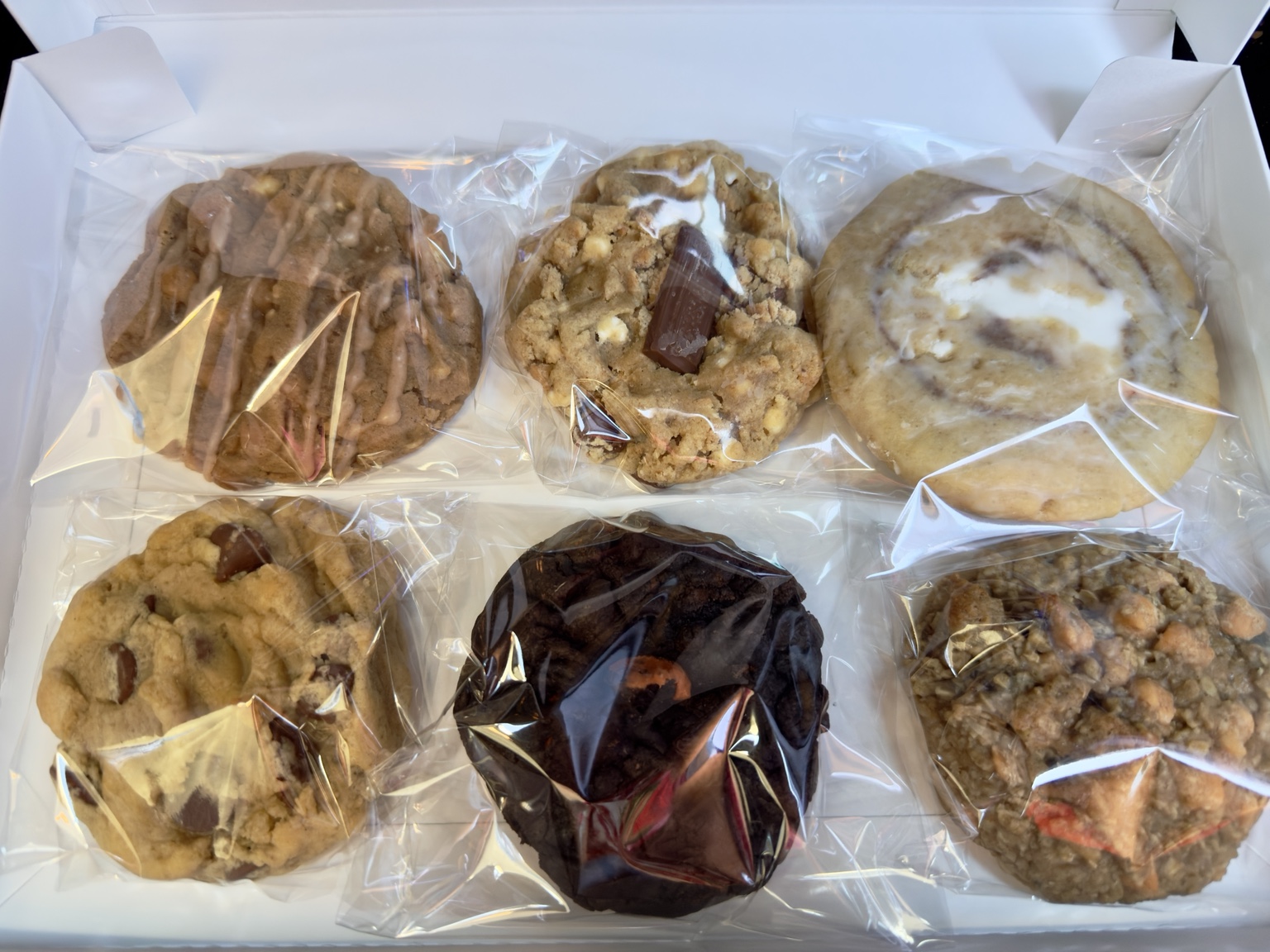 Open LadyBug Flight box showing all six individually wrapped cookies arranged in two rows of three